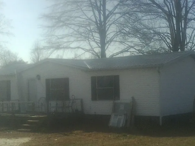New metal roof on a white painted brick home on a foggy morning in Romeoville